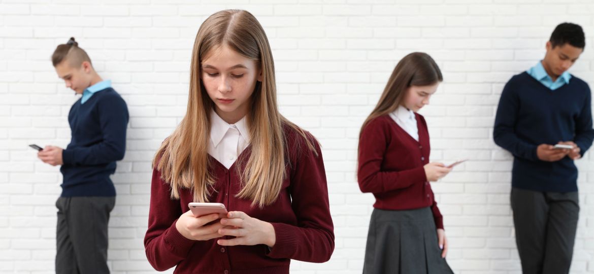 Teenagers,Using,Mobile,Phones,At,School.,Concept,Of,Internet,Addiction